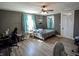Bright bedroom featuring a comfortable bed, modern ceiling fan, and plenty of natural light from the windows at 97 N Maple St, Pittsboro, IN 46167