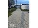 The gravel driveway is long, with a white fence on one side at 97 N Maple St, Pittsboro, IN 46167