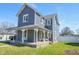 Charming two-story home with a covered front porch and gray siding at 97 N Maple St, Pittsboro, IN 46167