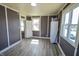 Sun-lit living room features modern floors, neutral wall color, and multiple windows at 97 N Maple St, Pittsboro, IN 46167