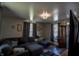 Inviting living room featuring large sectional couch and wood-look flooring at 97 N Maple St, Pittsboro, IN 46167