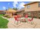 Spacious backyard features a fire pit surrounded by chairs with the patio just off the home at 10673 Rolling Springs Dr, Indianapolis, IN 46234