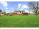 Spacious backyard with a patio area, fire pit, and lush green lawn at 10673 Rolling Springs Dr, Indianapolis, IN 46234