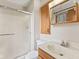 Bathroom featuring a shower with glass doors, vanity with marble top, and wood cabinet at 10673 Rolling Springs Dr, Indianapolis, IN 46234