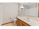 Bright bathroom featuring a vanity with marble top, wood cabinets, and a combined toilet and shower at 10673 Rolling Springs Dr, Indianapolis, IN 46234