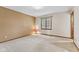 Bright, empty bedroom with neutral walls and a view from a window at 10673 Rolling Springs Dr, Indianapolis, IN 46234