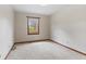Bedroom with carpet, trim, and a window providing natural light at 10673 Rolling Springs Dr, Indianapolis, IN 46234