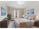 Stylized bedroom featuring a large bed with throw blanket, art, and windows that offer lots of natural light at 10673 Rolling Springs Dr, Indianapolis, IN 46234