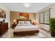 Inviting bedroom with a large bed, hardwood furniture, and stylish decor at 10673 Rolling Springs Dr, Indianapolis, IN 46234