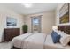 Bedroom featuring a queen size bed with blue pillows and a window with natural light at 10673 Rolling Springs Dr, Indianapolis, IN 46234