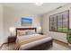 Cozy bedroom with a large window, hardwood furniture, and serene decor at 10673 Rolling Springs Dr, Indianapolis, IN 46234