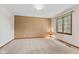 Empty bedroom with neutral walls and a large window offering natural light at 10673 Rolling Springs Dr, Indianapolis, IN 46234