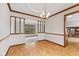 Open-concept dining room featuring hardwood floors and decorative trim at 10673 Rolling Springs Dr, Indianapolis, IN 46234