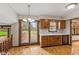 Bright eat-in kitchen with wood cabinets, laminate floors, and patio access at 10673 Rolling Springs Dr, Indianapolis, IN 46234