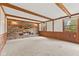 Spacious living room with brick fireplace, wood beam ceiling, and neutral carpeting at 10673 Rolling Springs Dr, Indianapolis, IN 46234