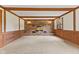 Large living room featuring a brick fireplace, exposed wood beams, and soft carpeting at 10673 Rolling Springs Dr, Indianapolis, IN 46234