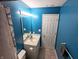 Bathroom with vanity, toilet, and blue walls at 11403 Fairweather Pl, Indianapolis, IN 46229
