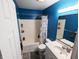 Bathroom with vanity, tub/shower combo, and blue walls at 11403 Fairweather Pl, Indianapolis, IN 46229