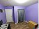 This purple bedroom features hardwood floors, white doors, and a closet at 11403 Fairweather Pl, Indianapolis, IN 46229