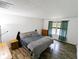 This bedroom features hardwood floors, white walls, a dresser, and a window with green curtains at 11403 Fairweather Pl, Indianapolis, IN 46229