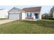 Charming one-story home featuring a well-manicured front yard and attached garage at 11403 Fairweather Pl, Indianapolis, IN 46229