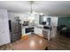 Open kitchen featuring stainless steel appliances, white cabinets, and an eat-in kitchen at 11403 Fairweather Pl, Indianapolis, IN 46229