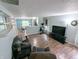Open-concept living room with wood floors, neutral paint, and an eat-in kitchen at 11403 Fairweather Pl, Indianapolis, IN 46229