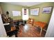 Home office with laminate floors, world map on wall, and desk with dual monitors at 11403 Fairweather Pl, Indianapolis, IN 46229