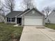Charming single-story home featuring a two-car garage and neutral exterior at 125 Hilltop Farms Blvd, Whiteland, IN 46184
