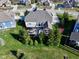 Aerial view of a beautiful home featuring an outdoor living space, screened porch, and lush green lawn at 13875 Ambria Dr, McCordsville, IN 46055