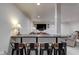 Finished basement wet bar area with counter seating and view to living space at 13875 Ambria Dr, McCordsville, IN 46055