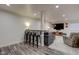 Basement bar area with counter seating and view to a comfortable living space at 13875 Ambria Dr, McCordsville, IN 46055