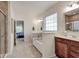 Serene bathroom offers a soaking tub, dual vanity, tiled shower, and access to the bedroom at 13875 Ambria Dr, McCordsville, IN 46055