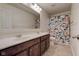 Bathroom with a double sink vanity and a shower featuring a floral shower curtain at 13875 Ambria Dr, McCordsville, IN 46055