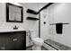 Updated bathroom features sleek, black hardware, floating shelves, and frameless shower at 13875 Ambria Dr, McCordsville, IN 46055
