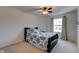 Bright bedroom with a ceiling fan and a queen-sized bed dressed with a patterned comforter and pillows at 13875 Ambria Dr, McCordsville, IN 46055
