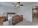 Bedroom with a wooden framed queen-sized bed complemented by a matching nightstand with neutral walls at 13875 Ambria Dr, McCordsville, IN 46055
