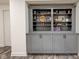 Custom built-in bookcase with decorative display shelves and storage cabinets in basement at 13875 Ambria Dr, McCordsville, IN 46055
