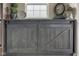 Cabinet with sliding barn doors with decorations on top of cabinet at 13875 Ambria Dr, McCordsville, IN 46055