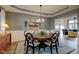 Elegant dining room featuring a chandelier, decorative rug, and comfortable seating at 13875 Ambria Dr, McCordsville, IN 46055