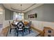 Charming dining room with a round wood table, tray ceiling, and elegant decor at 13875 Ambria Dr, McCordsville, IN 46055
