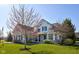 Beautifully landscaped two-story home with well-maintained lawn and welcoming facade at 13875 Ambria Dr, McCordsville, IN 46055