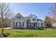 Stunning two-story home featuring a well-manicured lawn, professional landscaping and an inviting front facade at 13875 Ambria Dr, McCordsville, IN 46055