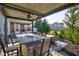 Covered outdoor living area features a bar-height fire table with granite countertop and modern seating at 13875 Ambria Dr, McCordsville, IN 46055