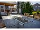 Close up of a modern outdoor fire table with a glass surround, adjacent to a screened porch at 13875 Ambria Dr, McCordsville, IN 46055