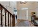 Grand foyer with high ceilings, hardwood floors, and a stylish chandelier, leading to a staircase at 13875 Ambria Dr, McCordsville, IN 46055