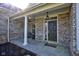 Charming front porch with comfortable seating, decorative elements, and brick accents at 13875 Ambria Dr, McCordsville, IN 46055