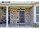 Welcoming covered front porch with comfortable seating, elegant columns, and decorative features at 13875 Ambria Dr, McCordsville, IN 46055