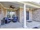 Inviting front porch features comfortable seating, stylish decor, and a welcoming ambiance at 13875 Ambria Dr, McCordsville, IN 46055