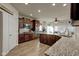 Large, open kitchen with stainless appliances, granite counters, wood cabinetry, and a large island at 13875 Ambria Dr, McCordsville, IN 46055
